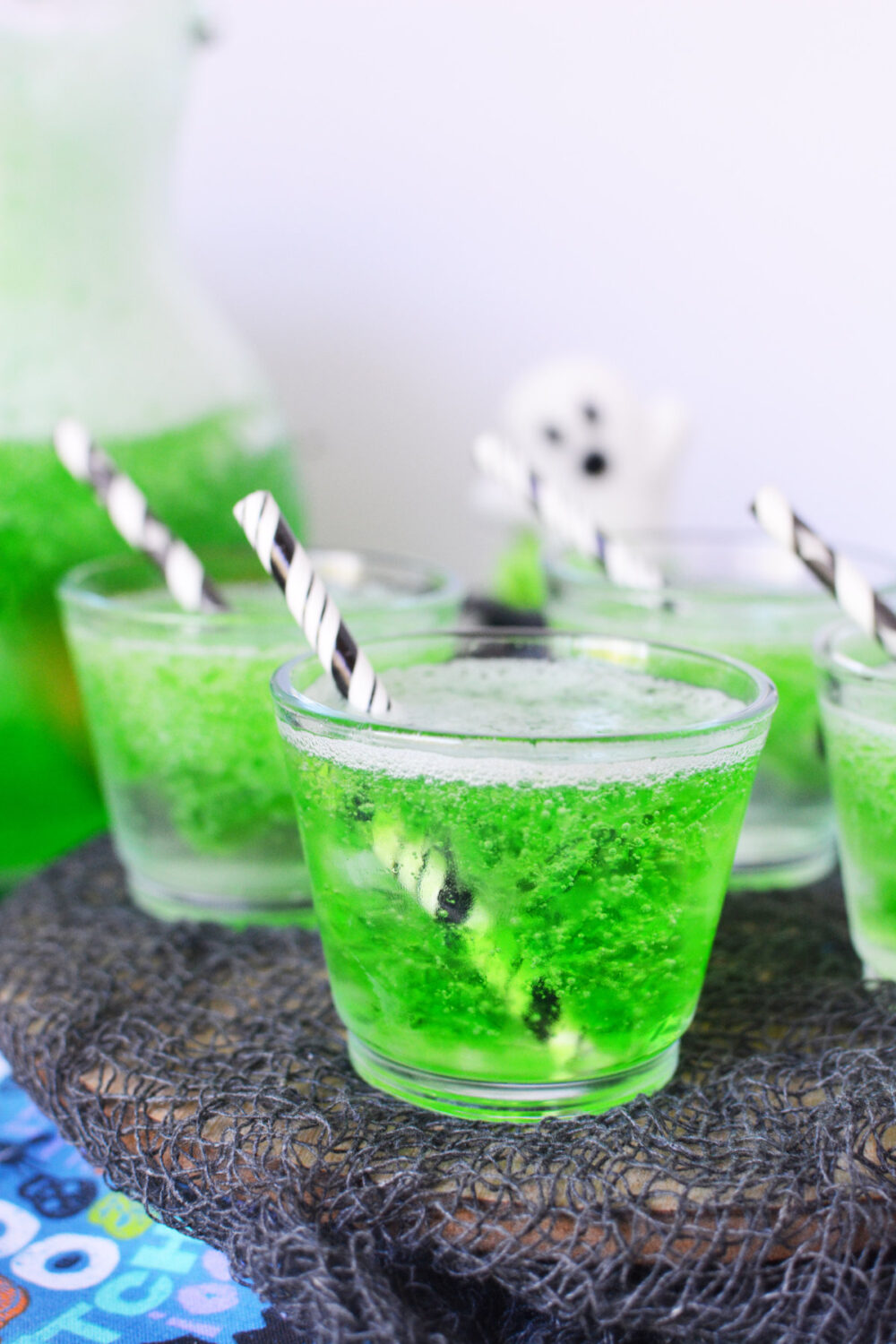 Clear cups with green Goblin Goo jello punch in them. 