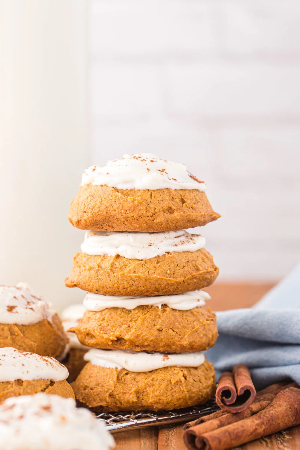 Stacked pumpkin cookies with icing.