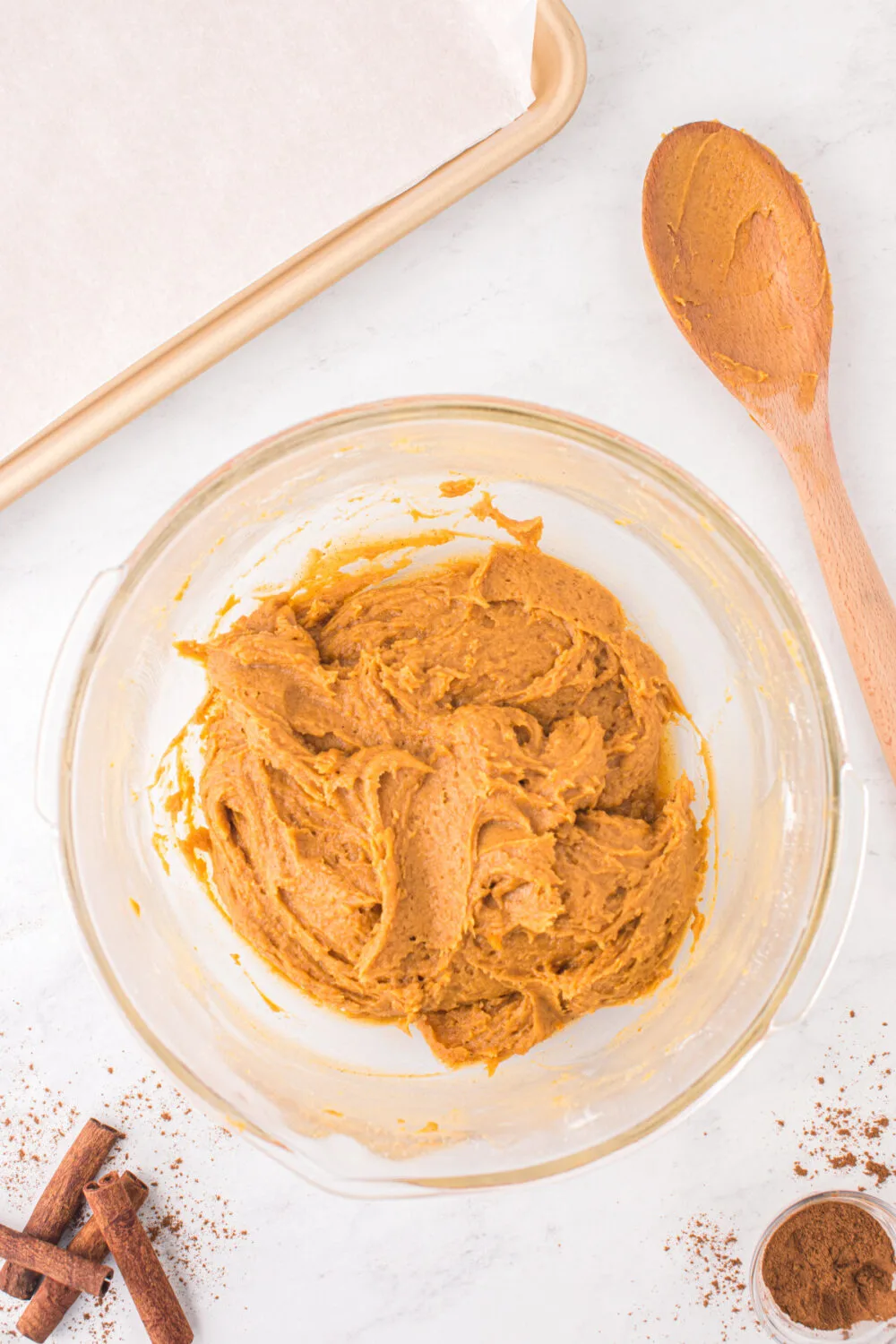 Pumpkin cookie dough in a mixing bowl.