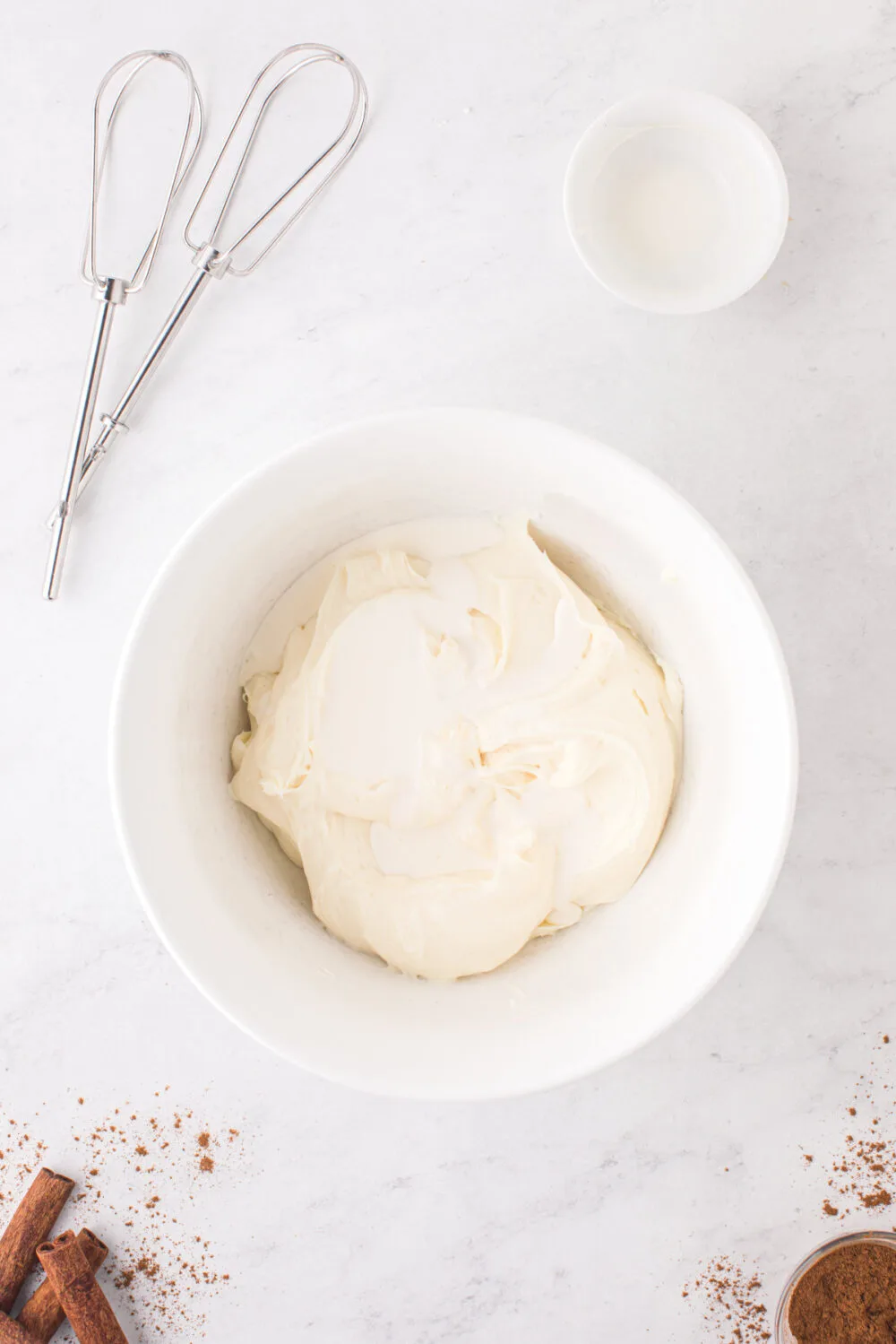 Cream cheese and heavy cream in a mixing bowl.