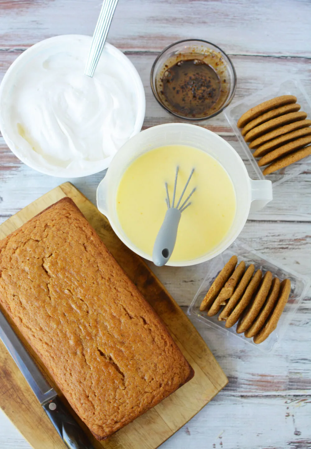 Loaf of pumpkin bread, pudding, cookies, coffee, and whipped topping. 