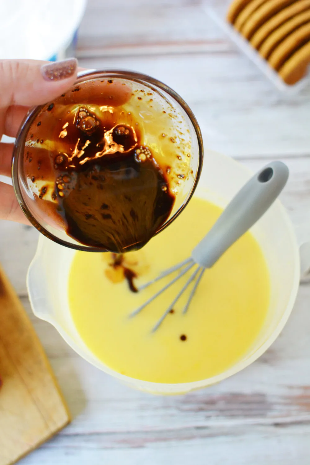 Adding coffee to vanilla pudding. 