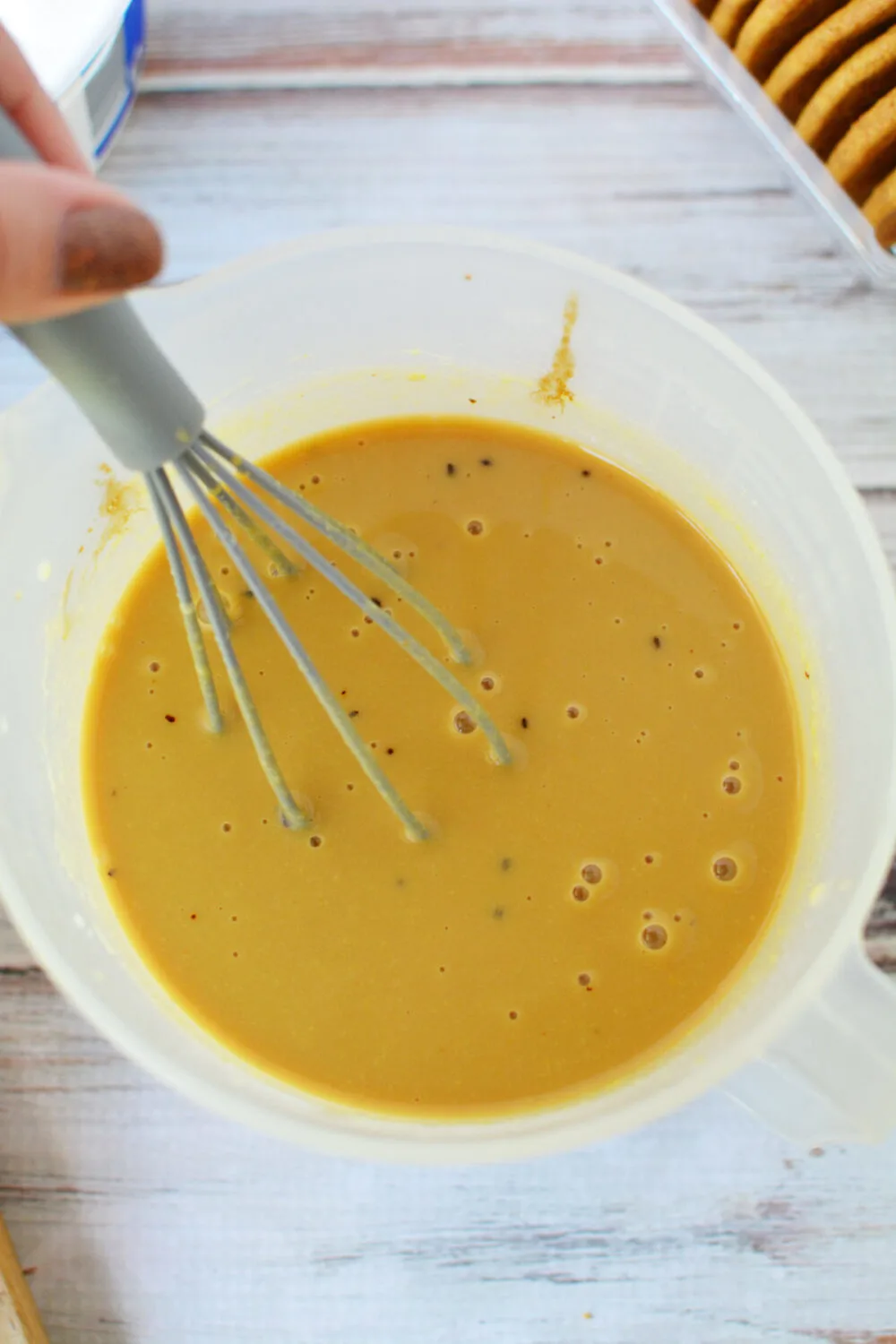 Coffee pudding in a bowl with a whisk. 