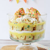 Layers of funfetti cake, cookies, pudding, and whipped topping in a trifle.