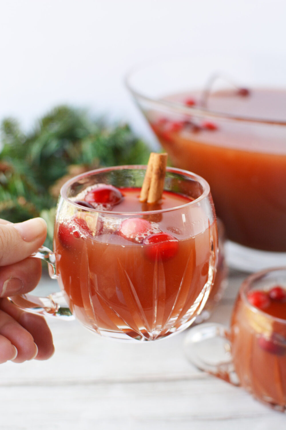 Holding a glass of Christmas punch. 