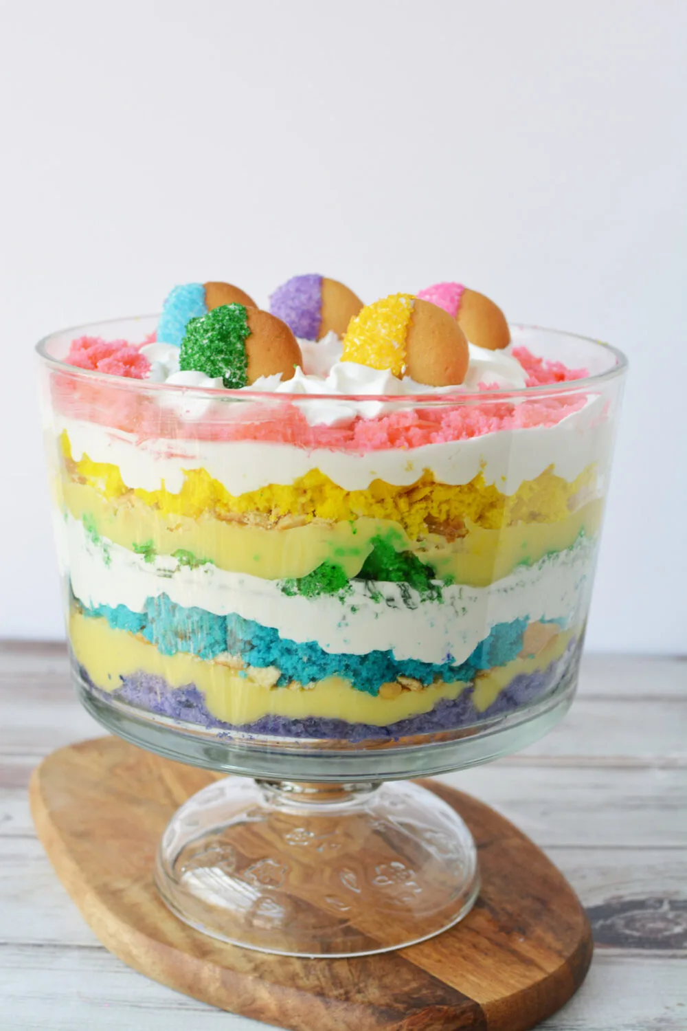 Layers of rainbow cake in a rainbow trifle dessert. 