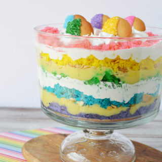 Rainbow trifle topped with colored cookies.