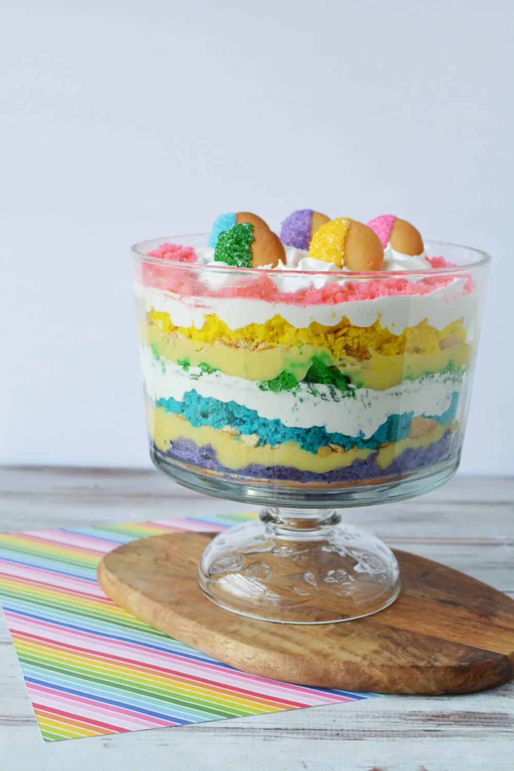 Rainbow trifle in a bowl on a board. 