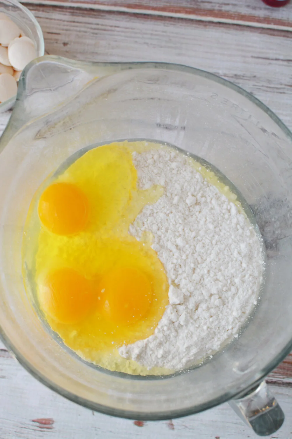Eggs and cake mix in a mixing bowl. 