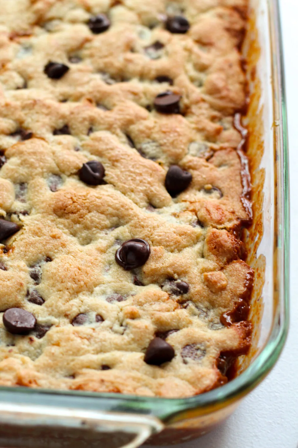 Caramel chocolate chip cookie bars in a pan after being baked. 