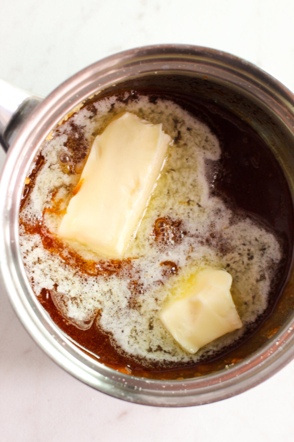Butter in a sauce pan with melted sugar. 