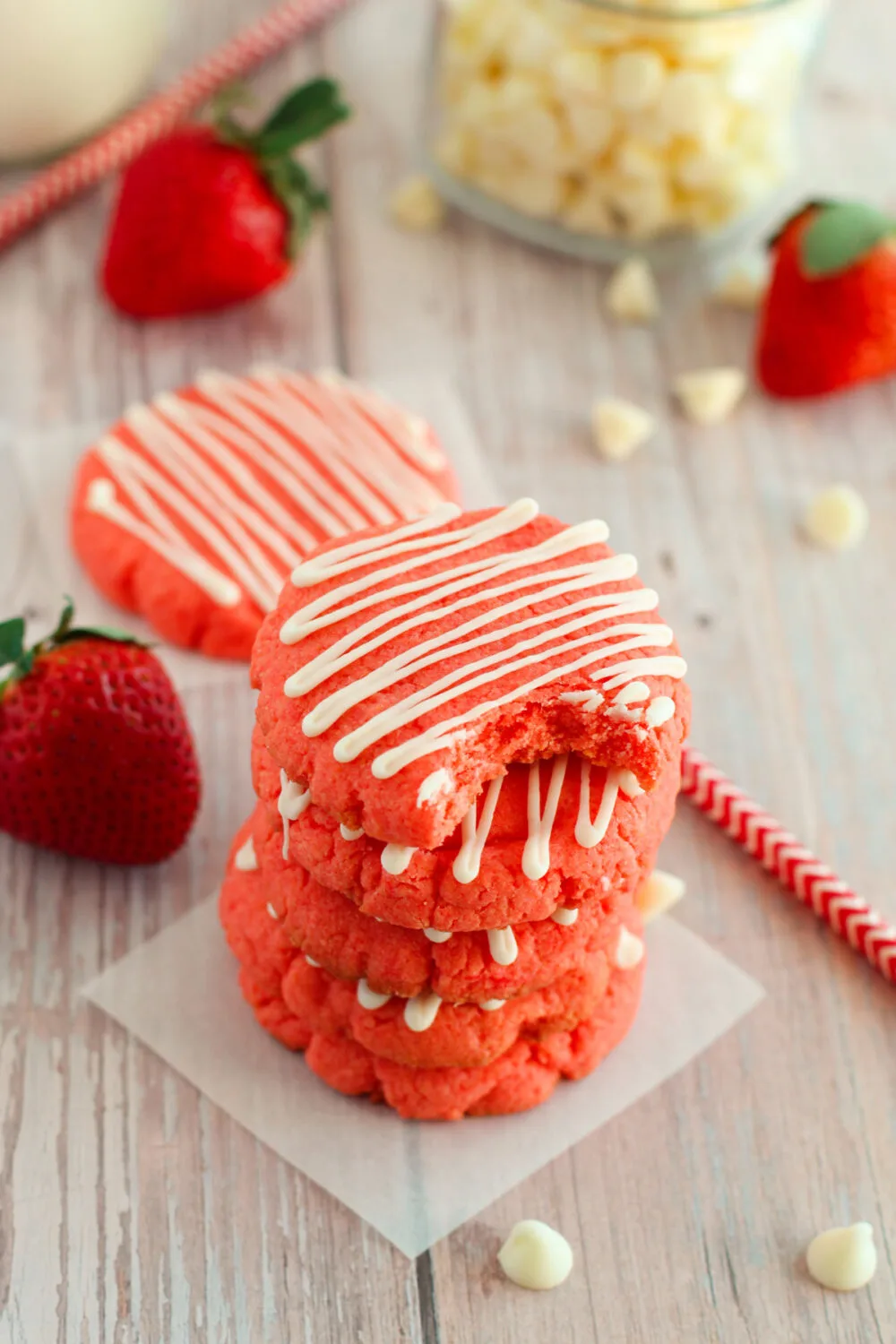 Stack of strawberry cookies with a white chocolate drizzle. 