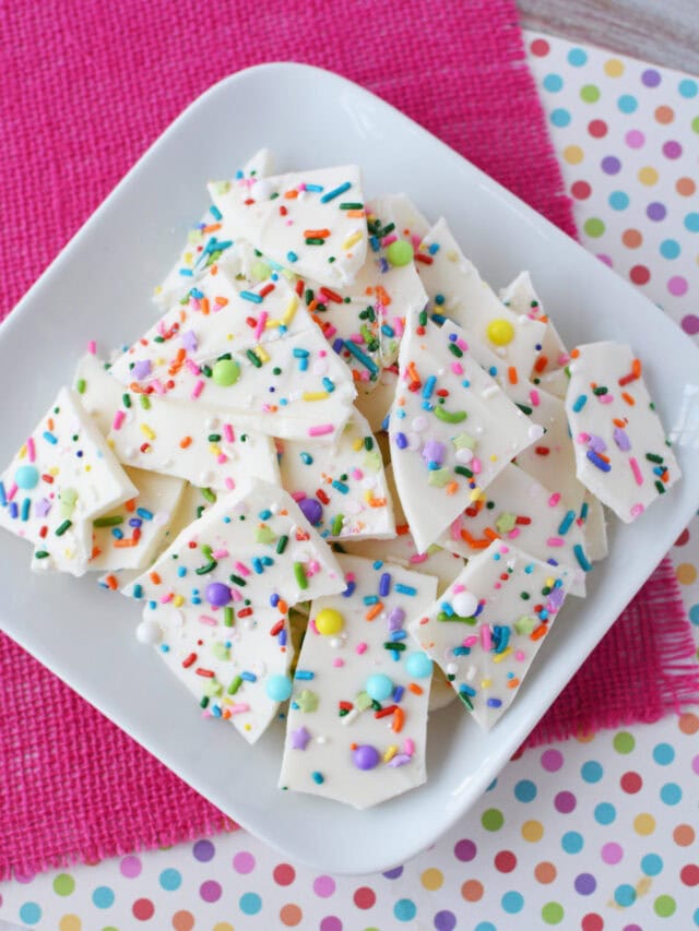 Pieces of confetti bark candy on a plate.