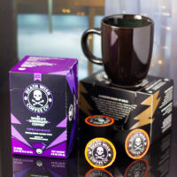 Boxes of Death Wish coffee, K-cups, and a mug.