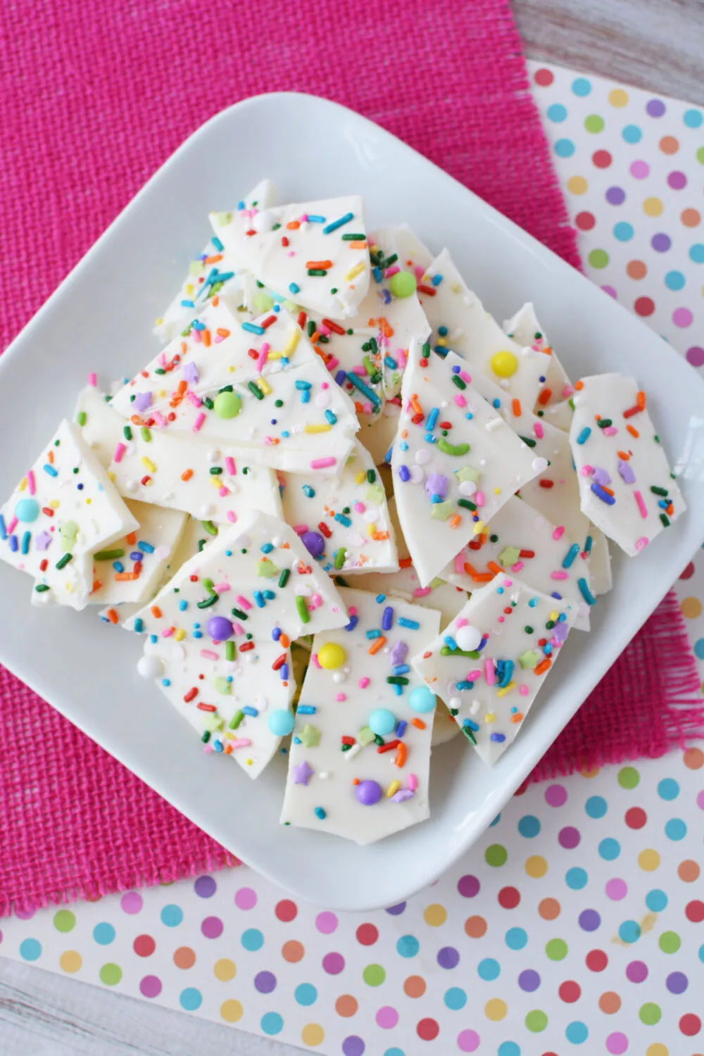 Pieces of confetti bark candy on a plate. 