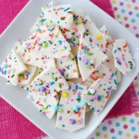 Pieces of confetti bark candy on a plate.