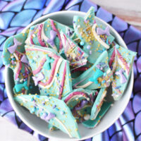Bowl of mermaid bark candy on top of scale fabric.