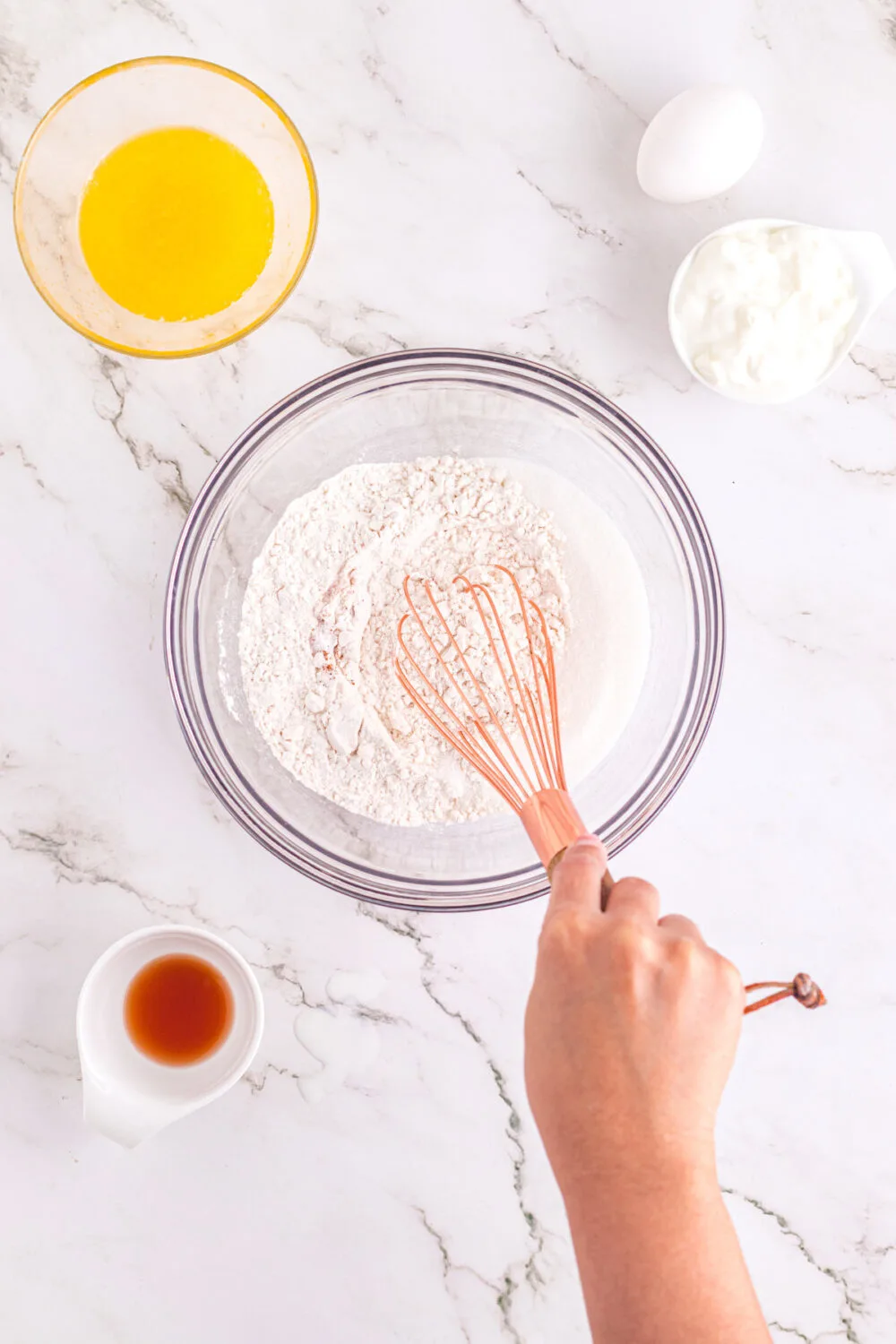 Whisking dry ingredients in a mixing bowl. 