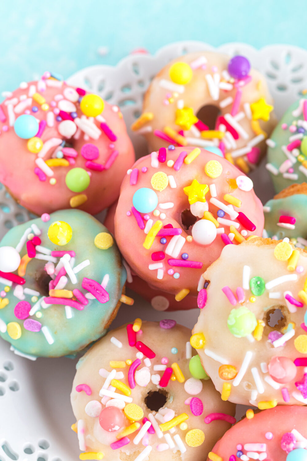 Mini donuts with colorful glaze and sprinkles. 