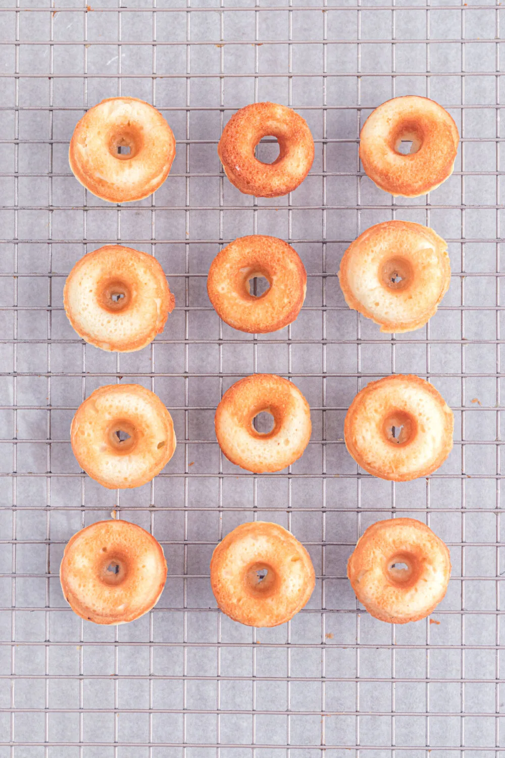 Baked mini donuts on a cooling rack. 