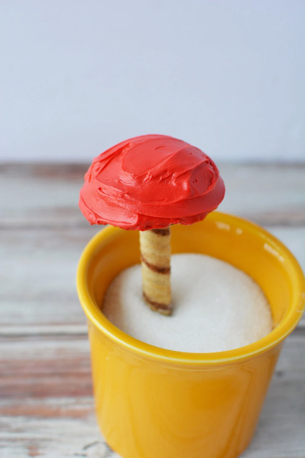 Edible toadstool in a cup filled with sugar. 