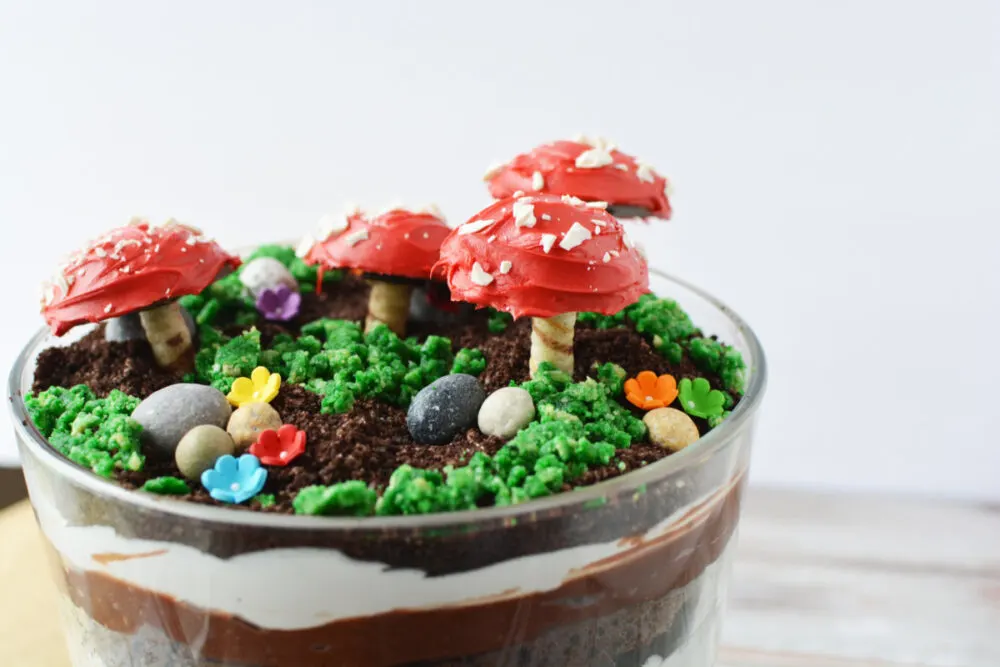 Fairy garden trifle with cookie toadstools, candy rocks, and edible moss. 
