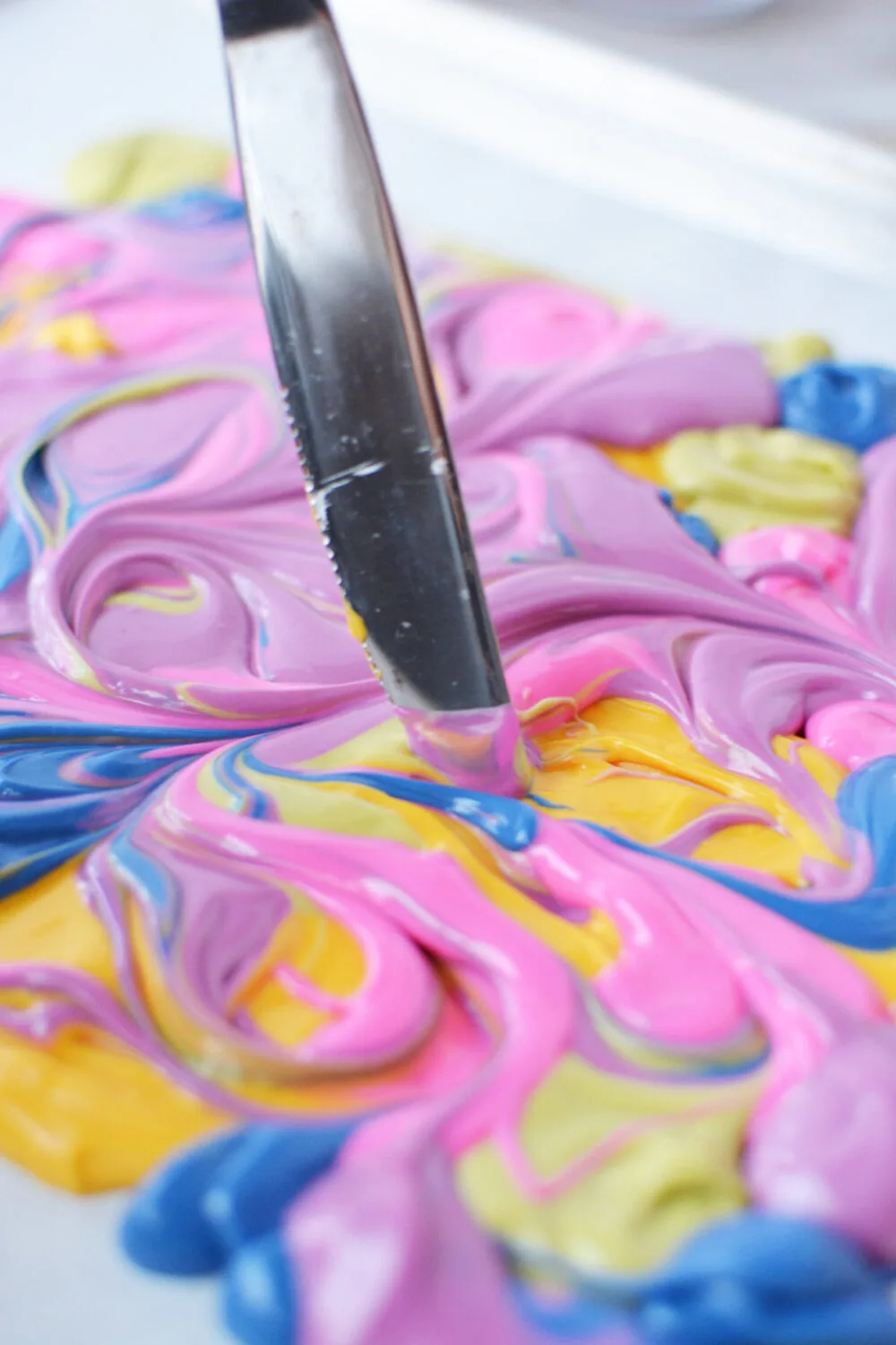 Dragging a knife through candy melts to swirl. 