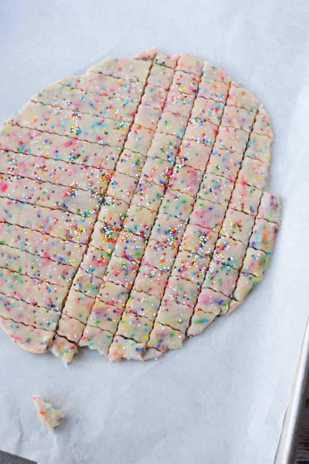 Shortbread cookie dough cut into tiny squares.