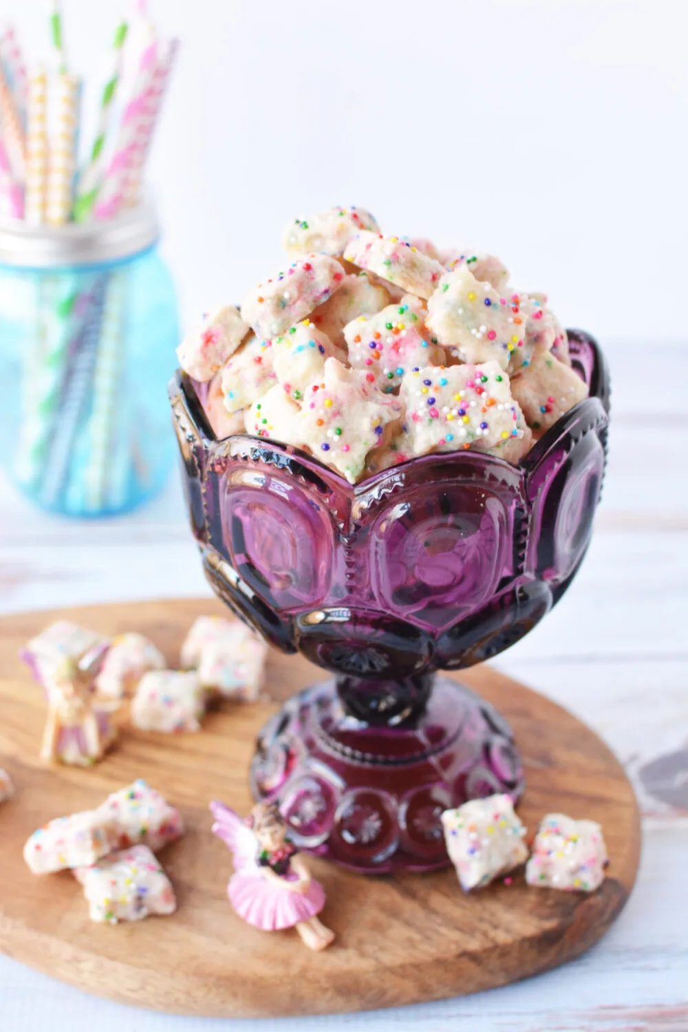 Purple cup filled with tiny shortbread bites. 