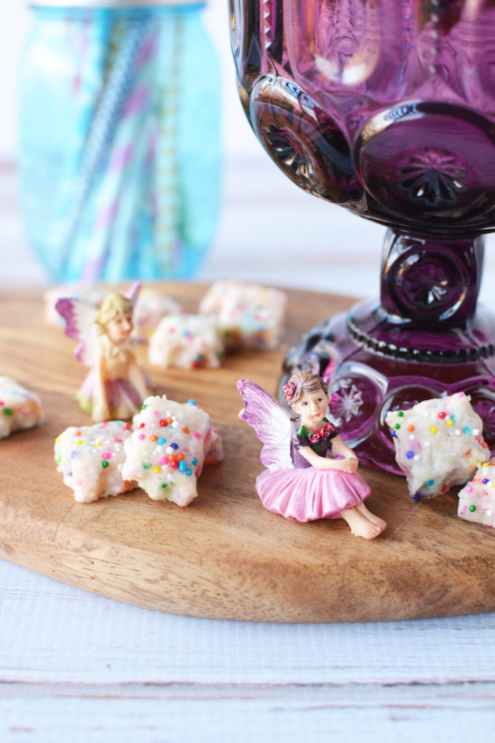 Little shortbread cookies next to a purple chalice and a fairy. 