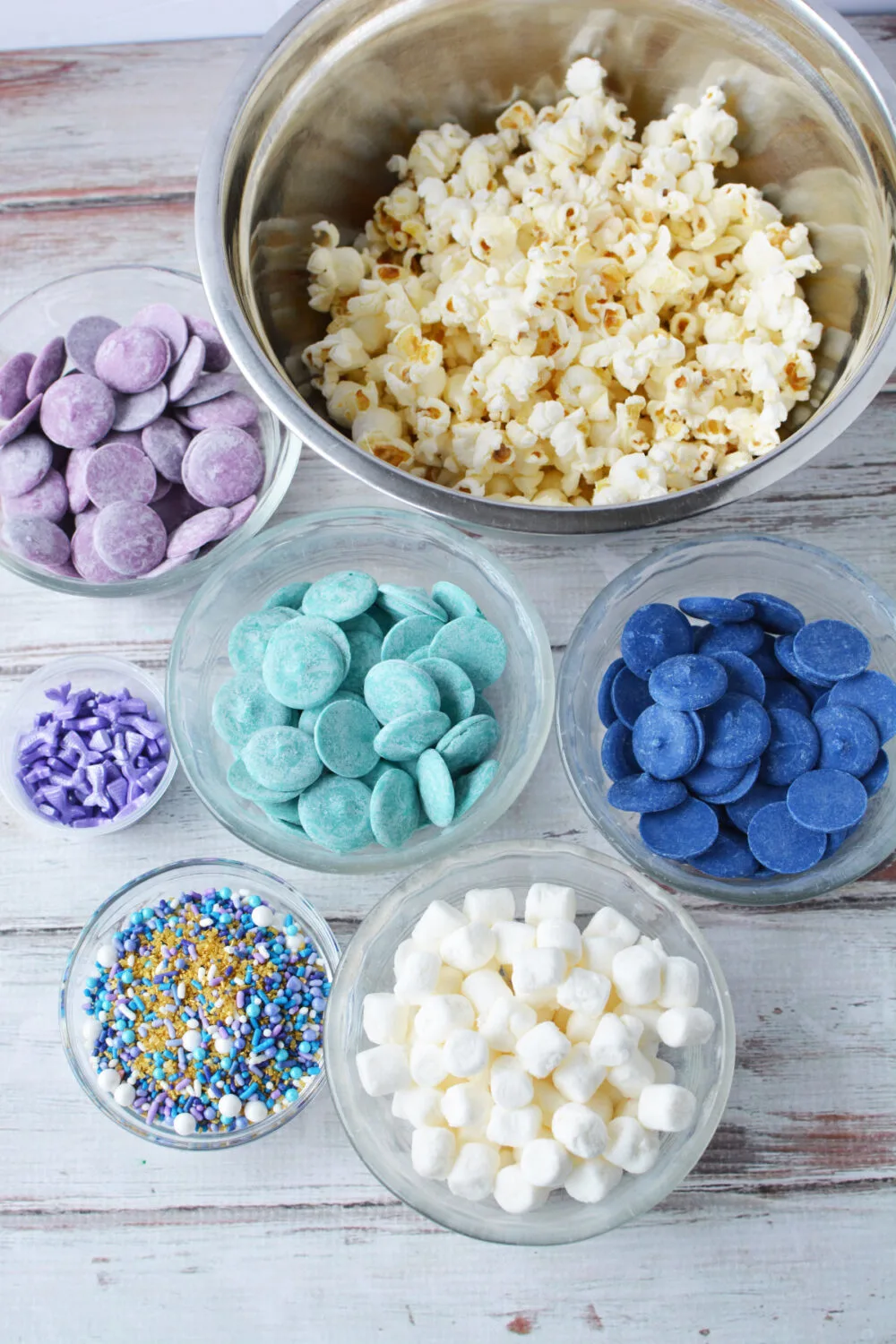 Bowls of popcorn, candy melts, and sprinkles. 