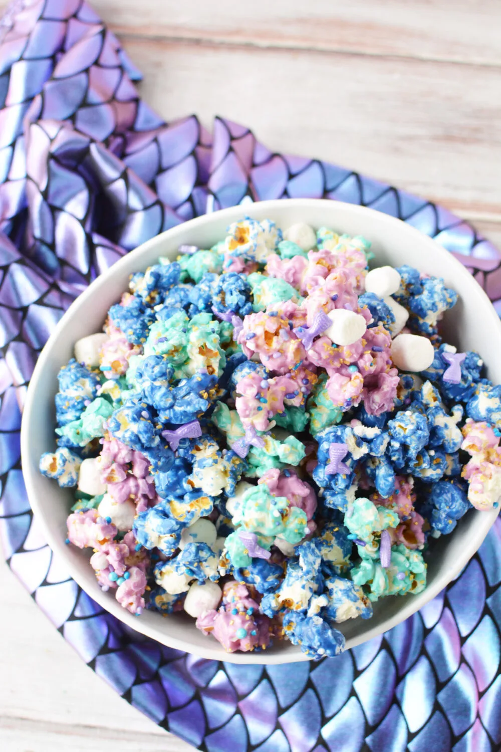Purple, blue, and teal popcorn in a bowl. 