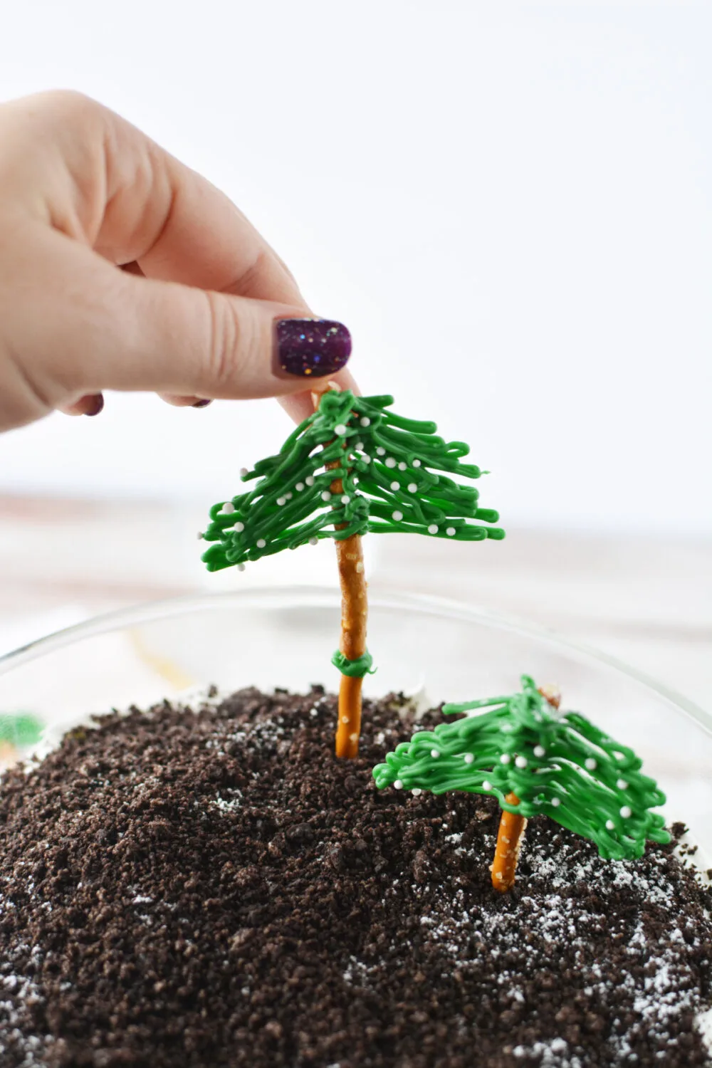 Adding pretzel trees to the top of a trifle. 