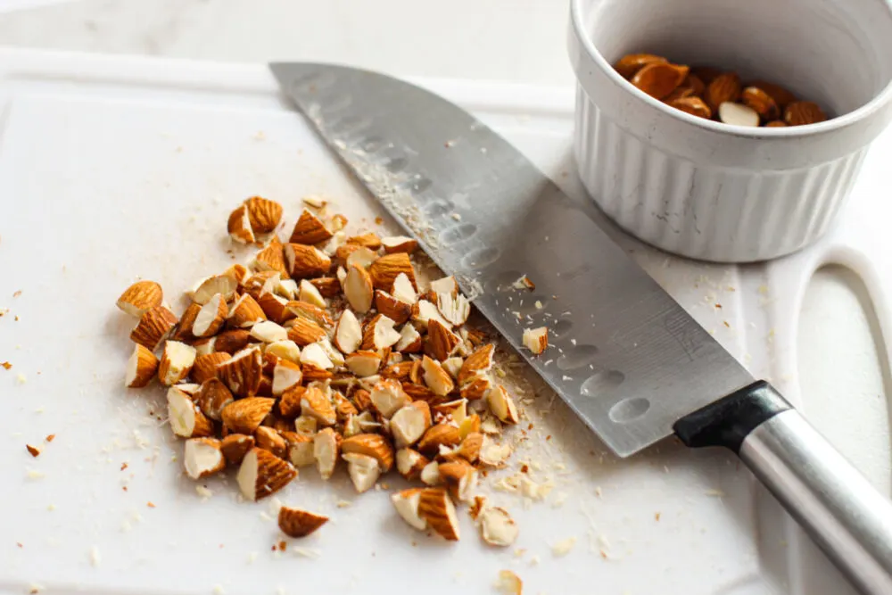 Chopping nuts on a board. 
