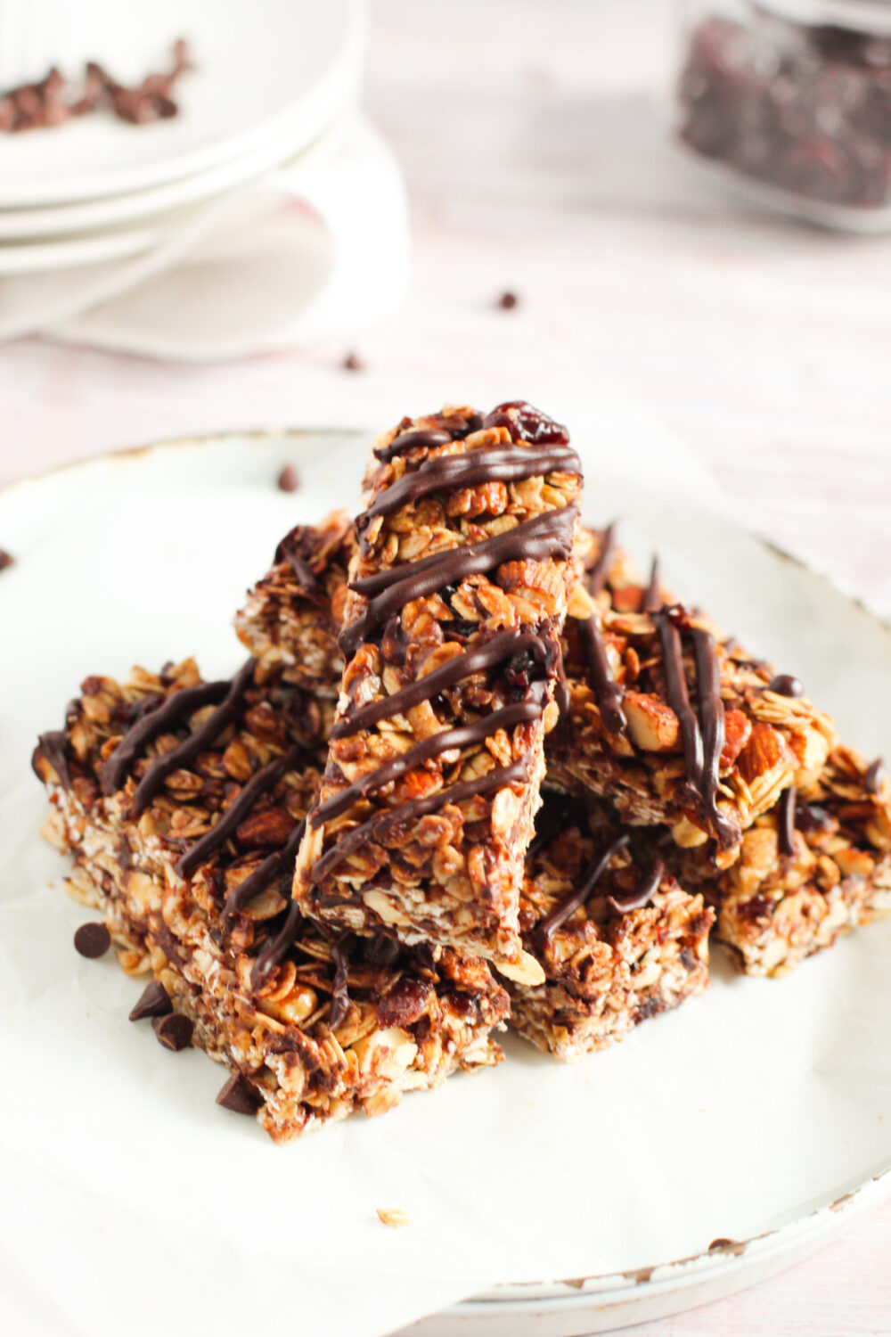 Chocolate cherry granola bars stacked on a plate. 
