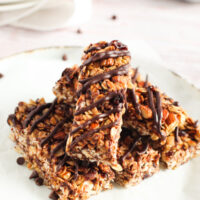 Chocolate cherry granola bars stacked on a plate.