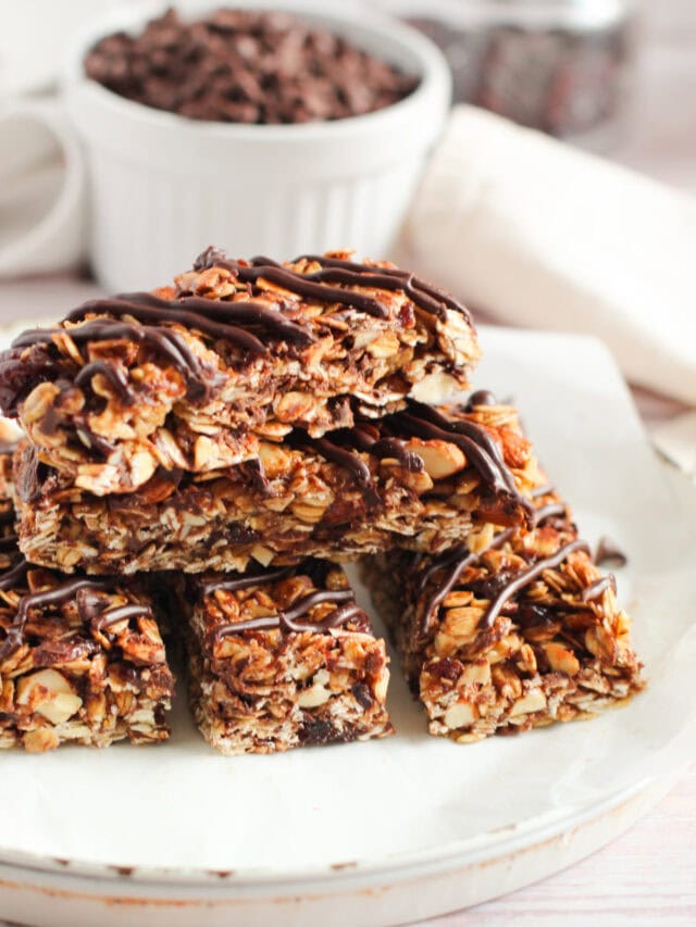 Stacked granola bars with chocolate drizzle.