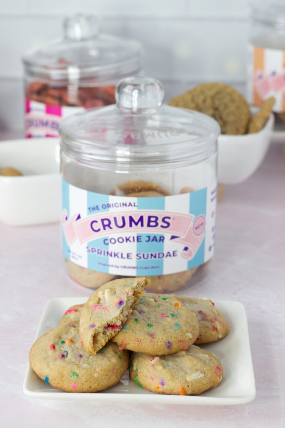 Sprinkle Sundae cookies on a plate by the cookie jar container. 