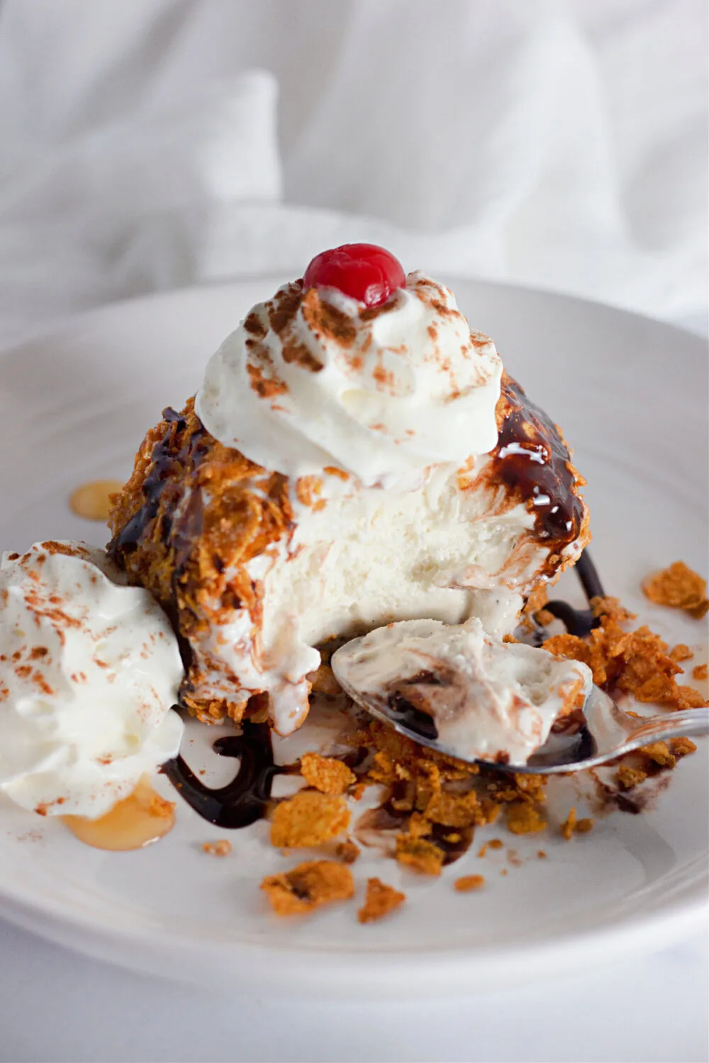 Eating fried ice cream on a plate.