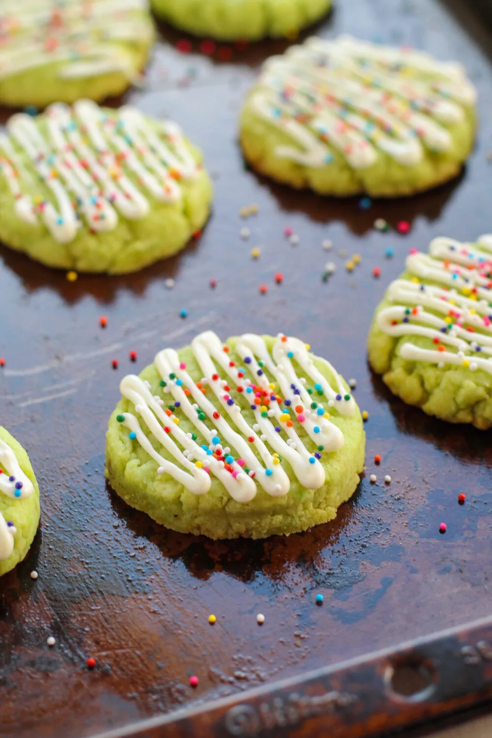 Nonpareils sprinkled onto lime cookies. 