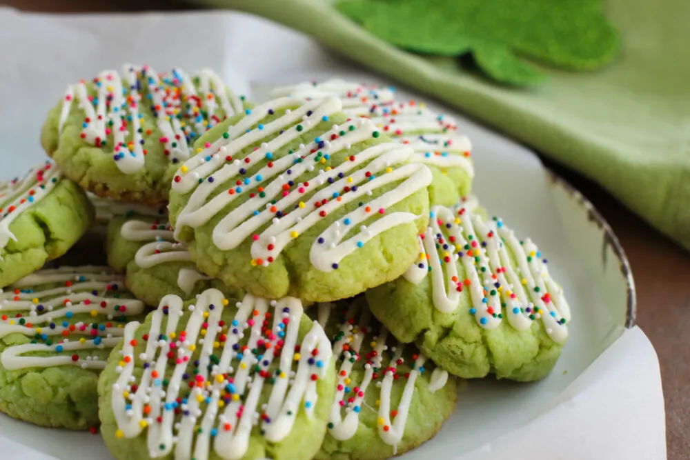 Lime cookies in a pile on a plate.