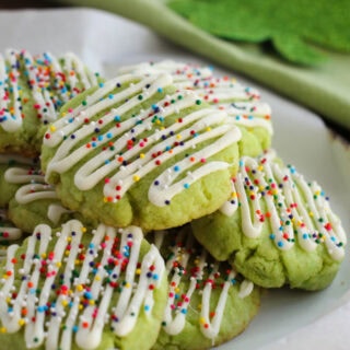 Lime cookies in a pile on a plate.