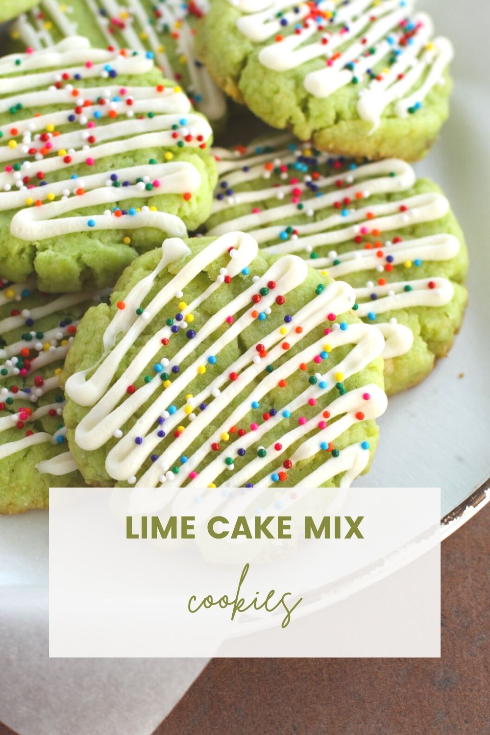 Lime cookie with white chocolate drizzle and rainbow nonpareils on a plate. 