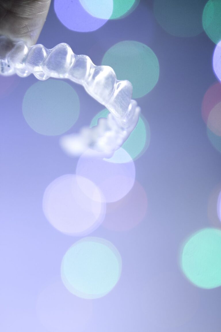 Clear aligners with a purple background.