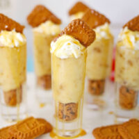 Cookie pudding shots on a tray with more Biscoff cookies.