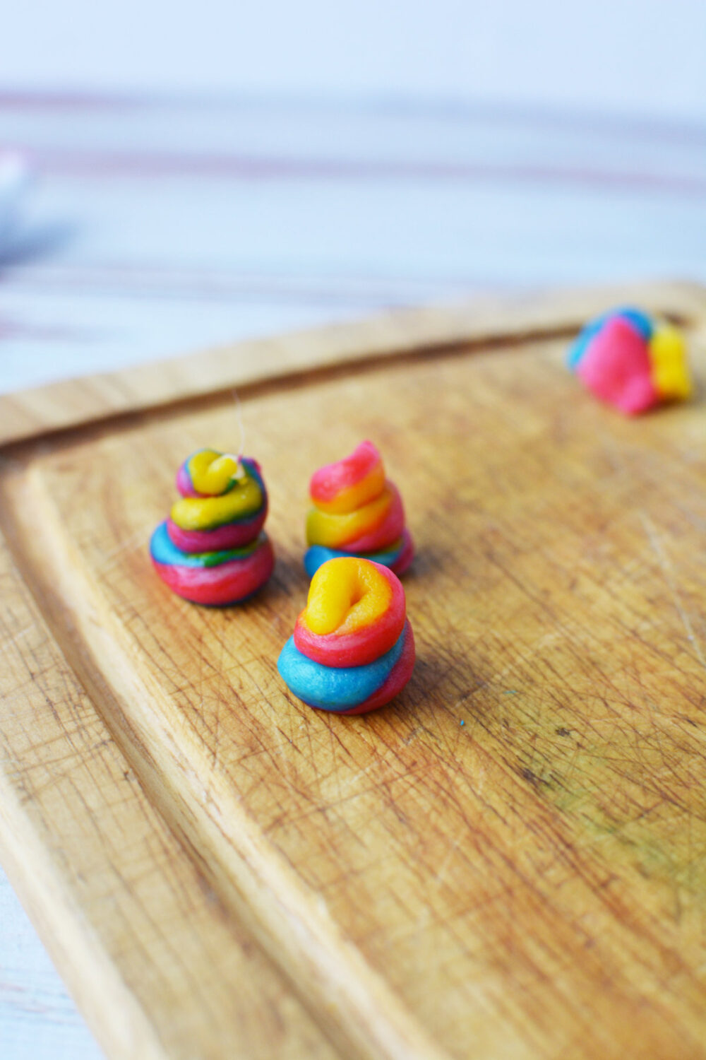 Rainbow dough in poop shapes. 