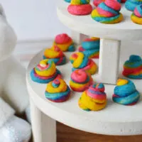 Rainbow poop unicorn shortbread cookies on a white display table.