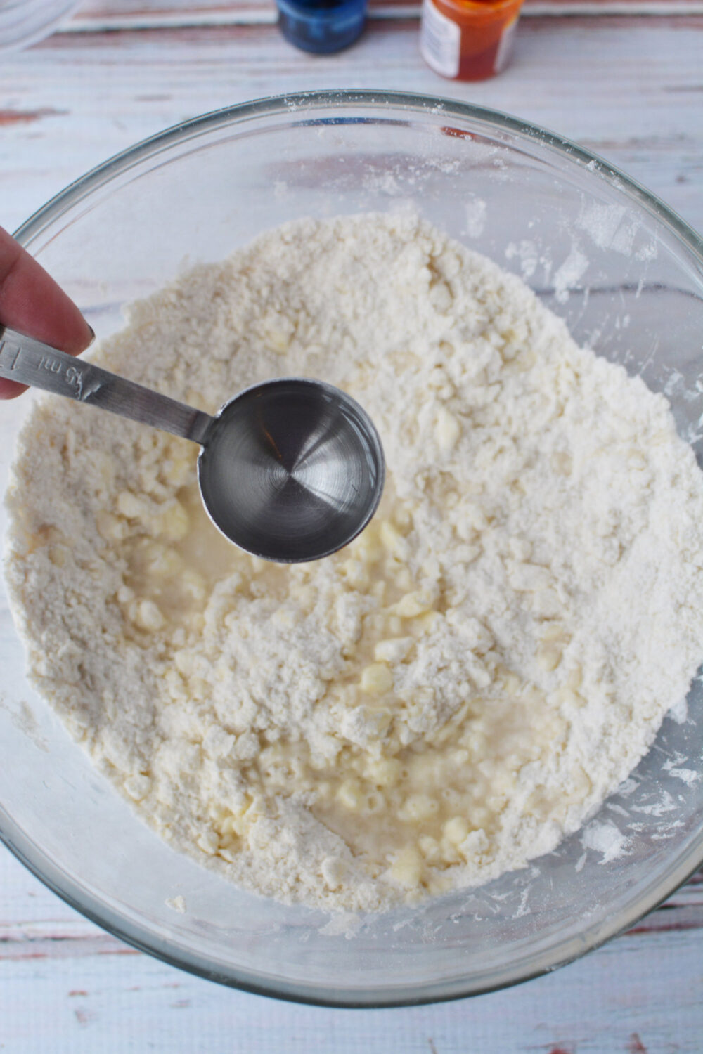 Adding water to cookie dough. 