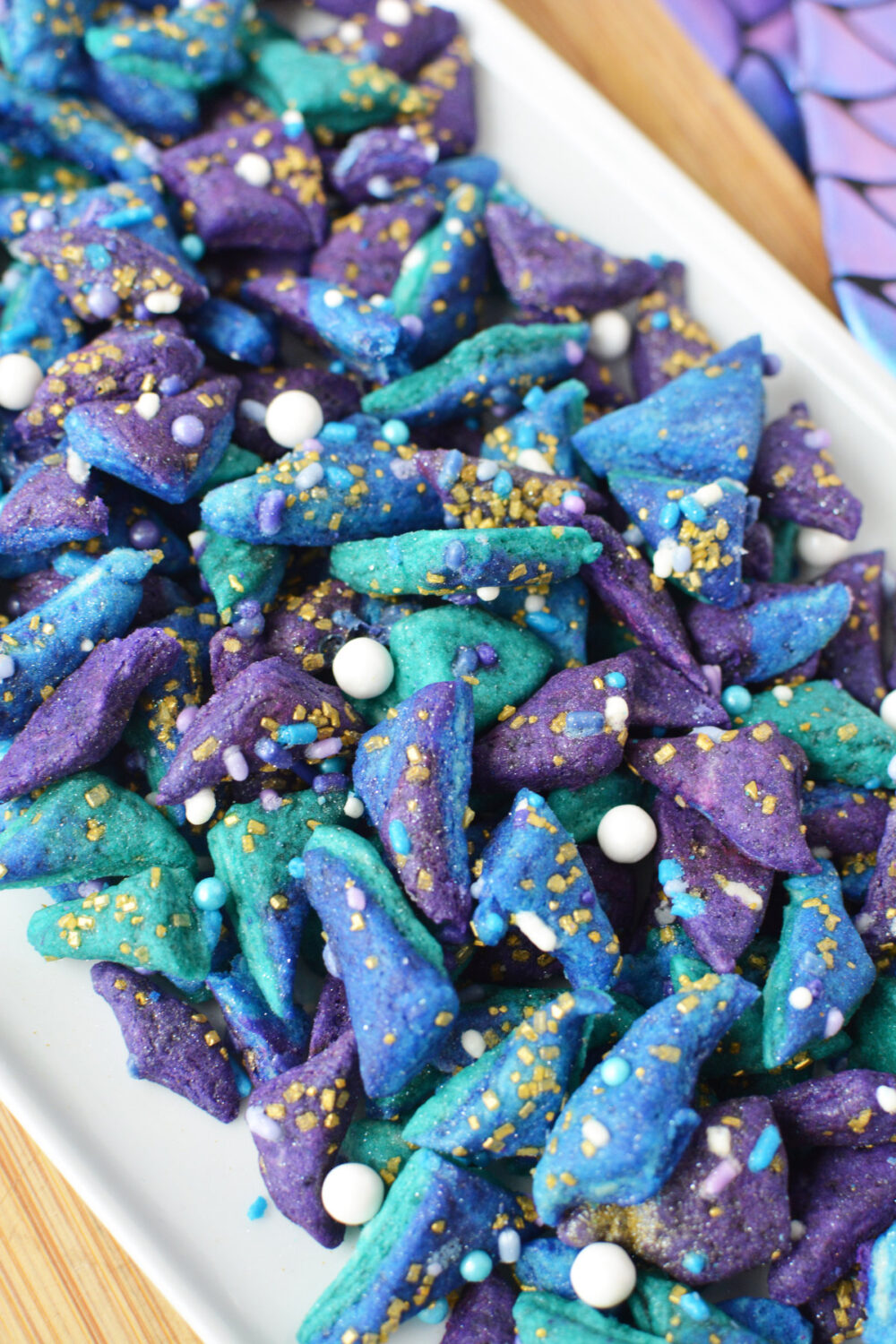 A pile of teeny tiny mermaid cookies on a tray. 
