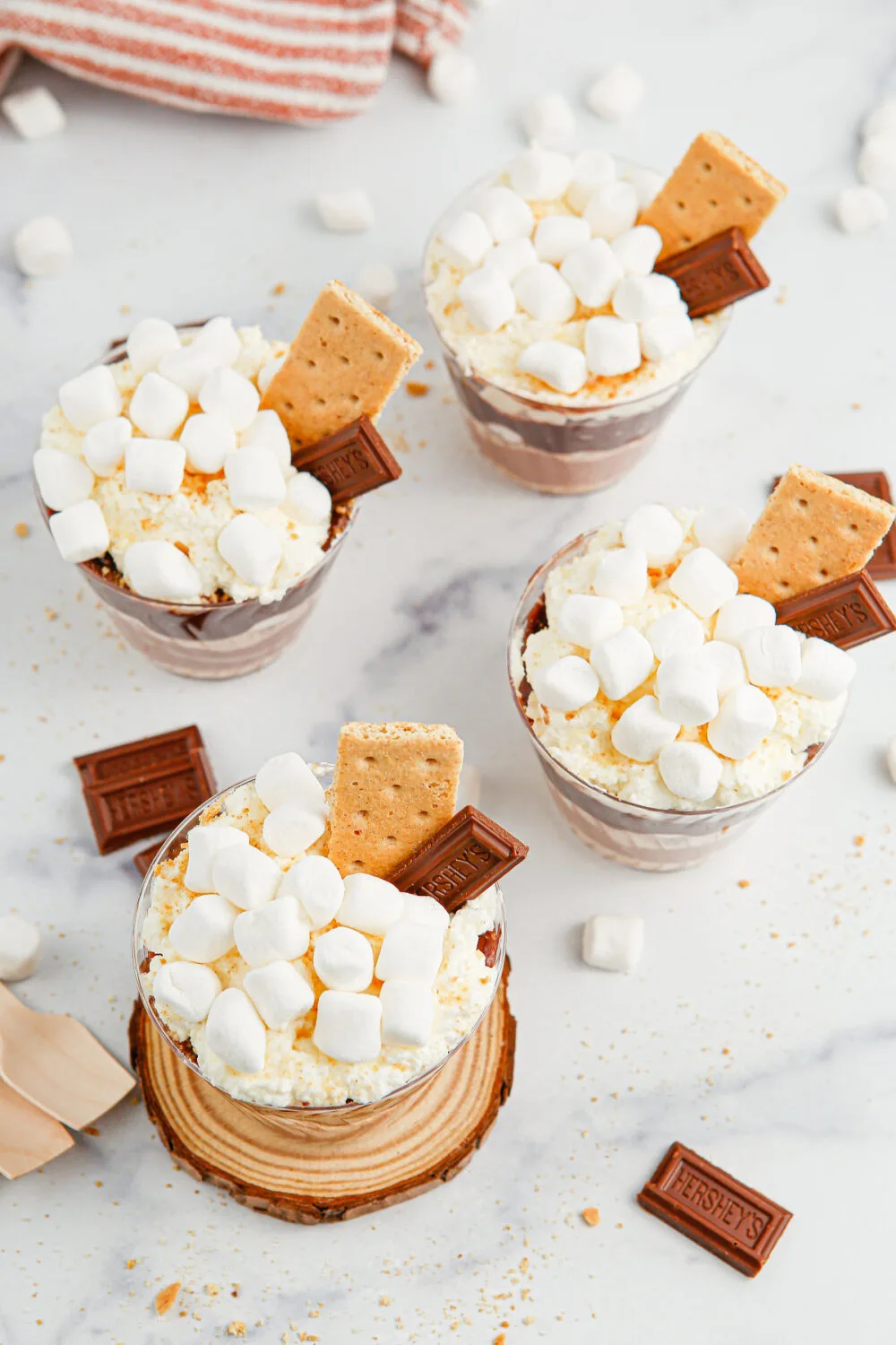 Tops of s'mores pudding cups with whipped cream, marshmallows, and graham crackers. 